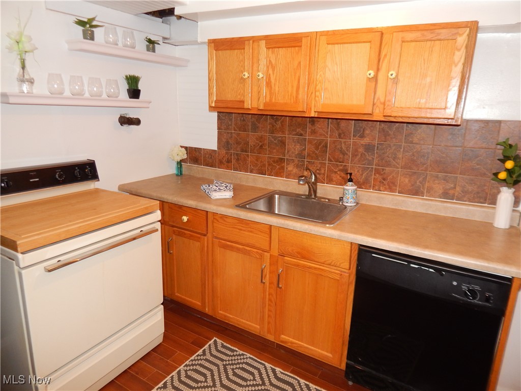 5961 Broadview Road Parma, OH 44134 - Photo 20 of 34 Basement Kitchen featuring backsplash, light laminate countertops, dishwasher, open shelves, and white stove