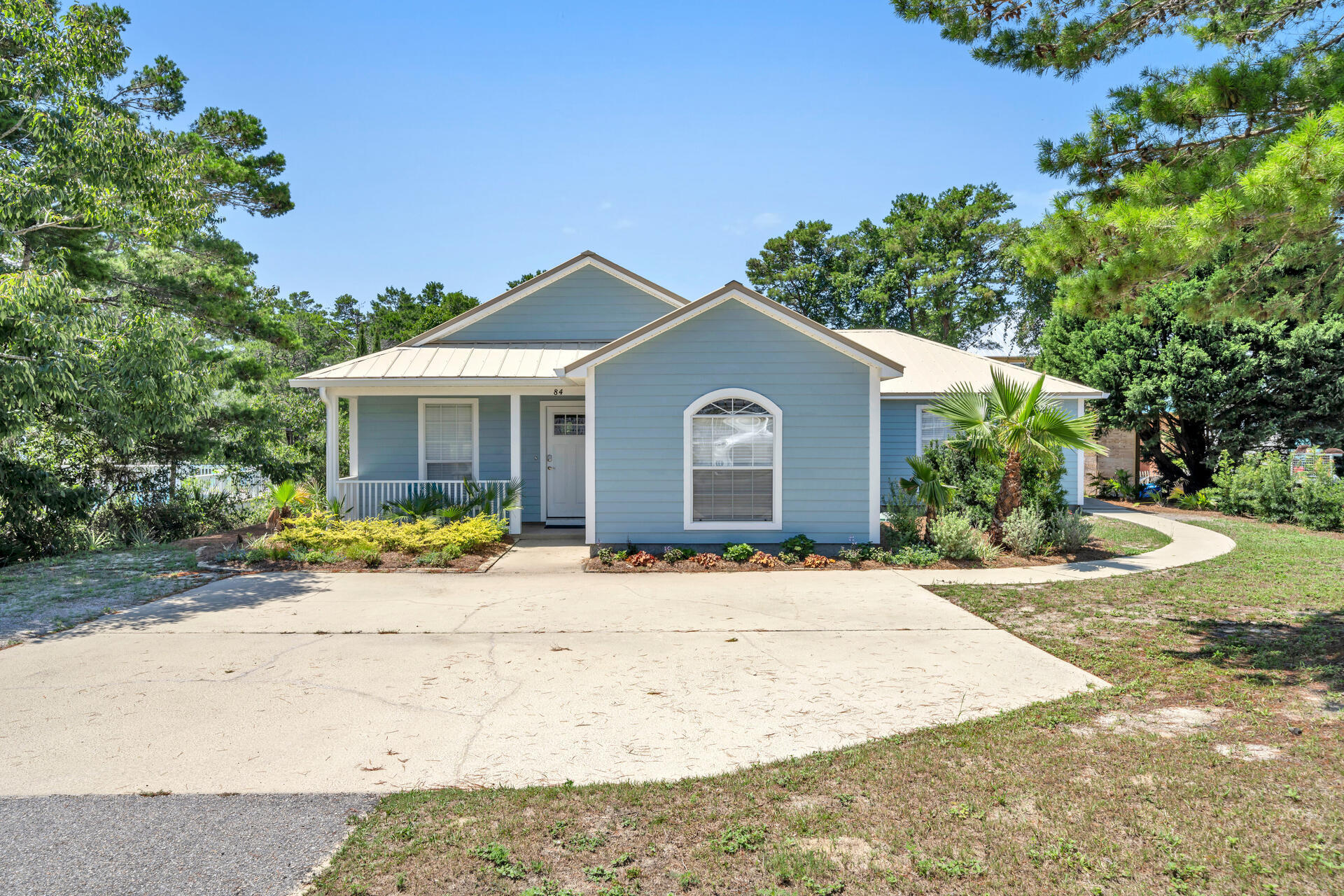 84 Vicki Street Santa Rosa Beach, FL 32459 - Photo 1 of 39 a front view of a house with a garden