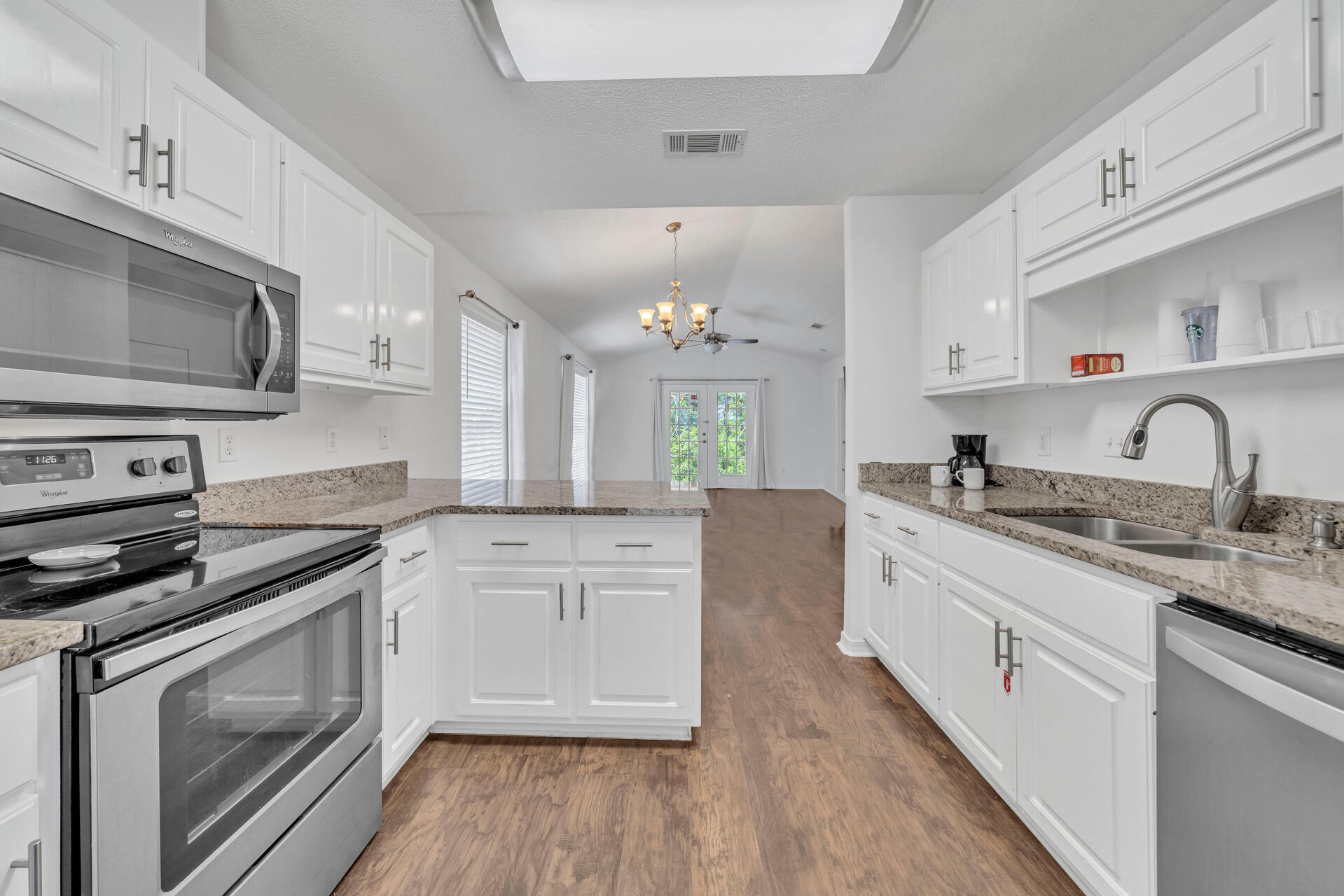 84 Vicki Street Santa Rosa Beach, FL 32459 - Photo 18 of 39 a kitchen with granite countertop a sink stove and cabinets