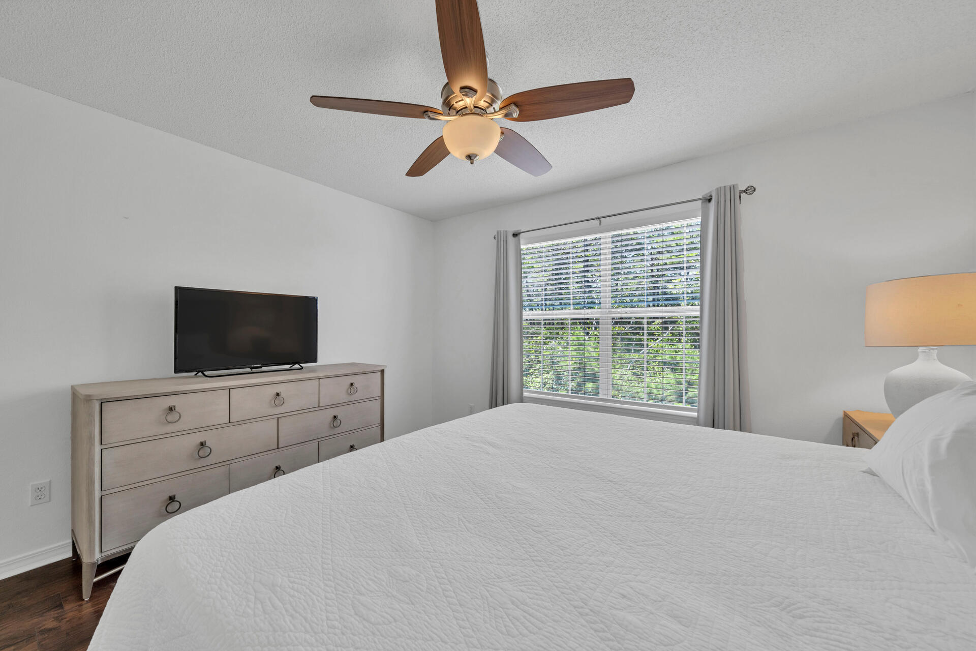 84 Vicki Street Santa Rosa Beach, FL 32459 - Photo 23 of 39 a bedroom with a bed a window and a flat tv screen