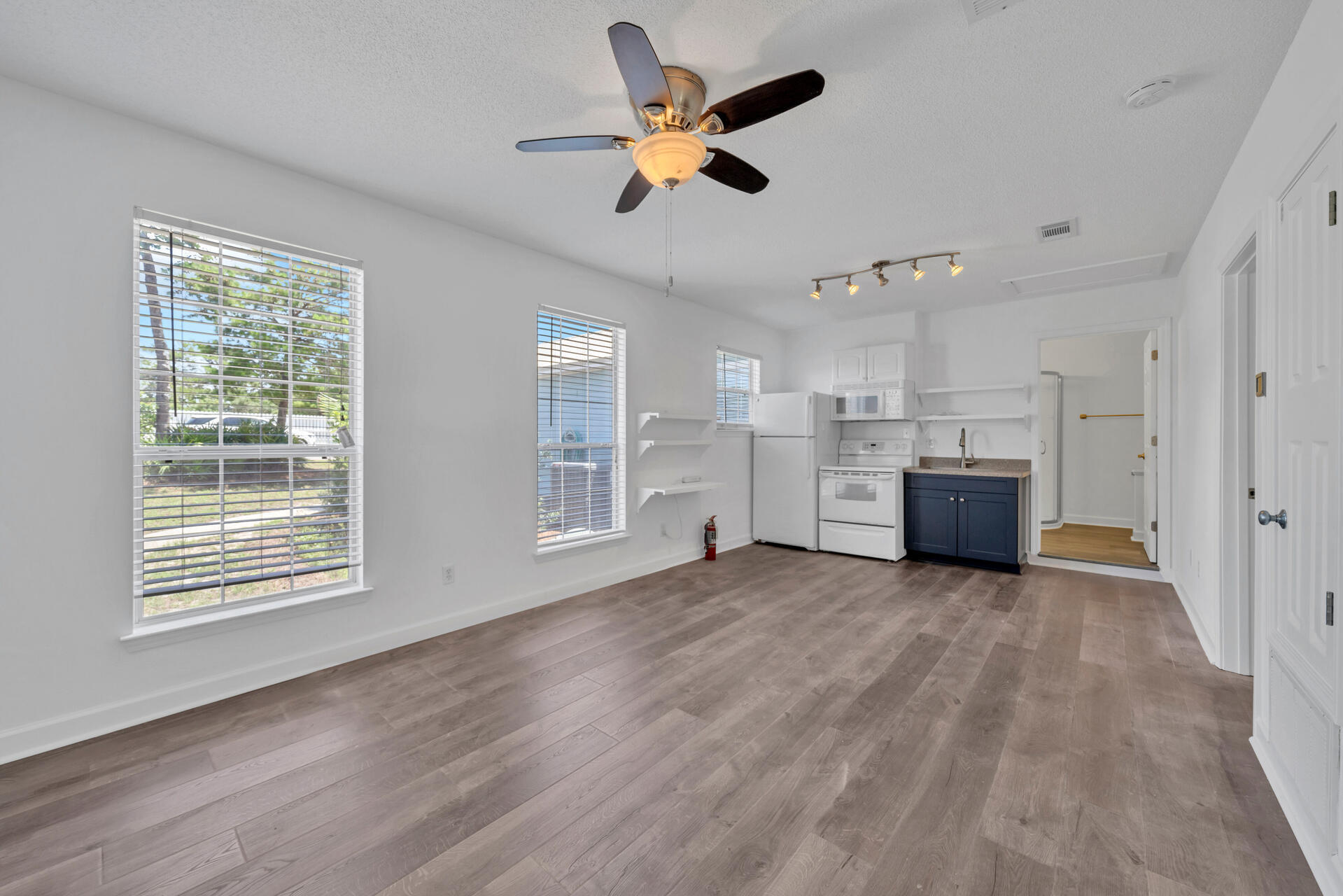 84 Vicki Street Santa Rosa Beach, FL 32459 - Photo 31 of 39 a view of an empty room with a kitchen and wooden floor