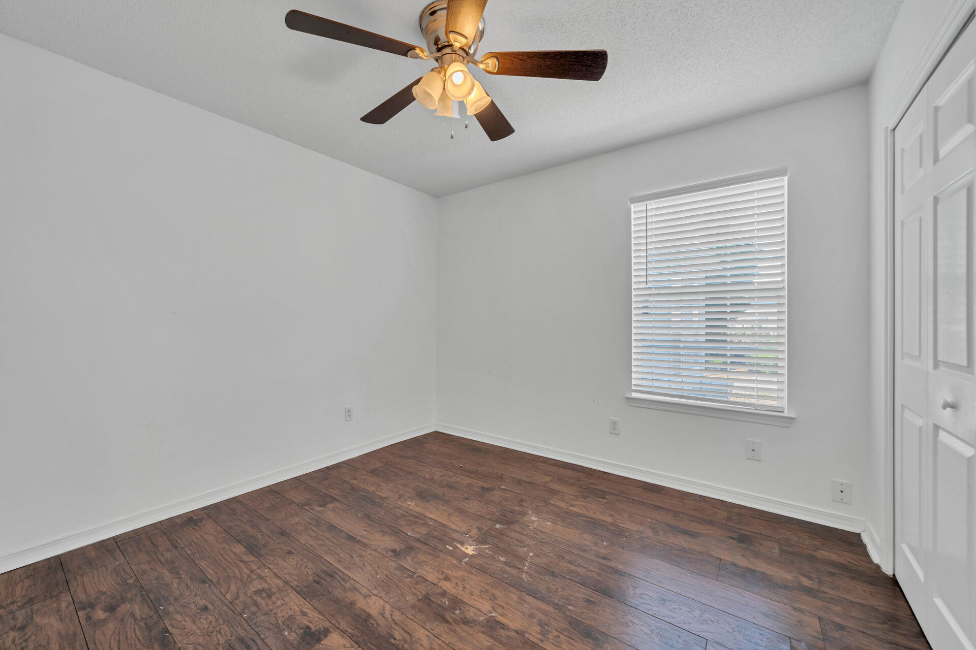 84 Vicki Street Santa Rosa Beach, FL 32459 - Photo 8 of 39 an empty room with a window and a fan