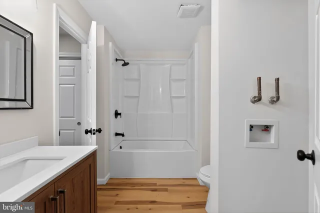 a bathroom with a bathtub and a sink