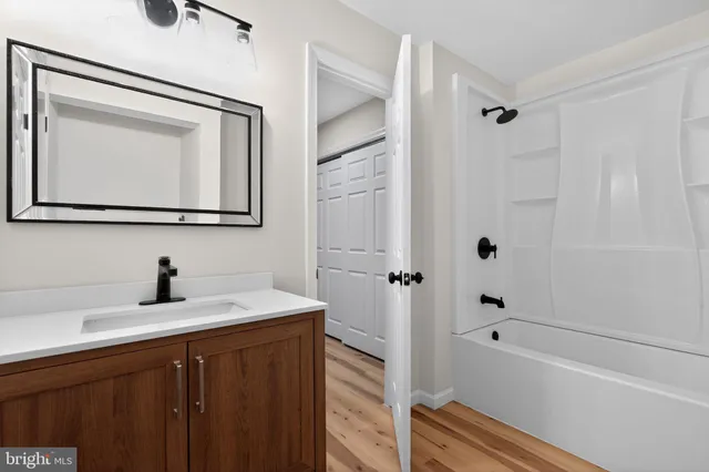 a bathroom with a sink a mirror and a bathtub