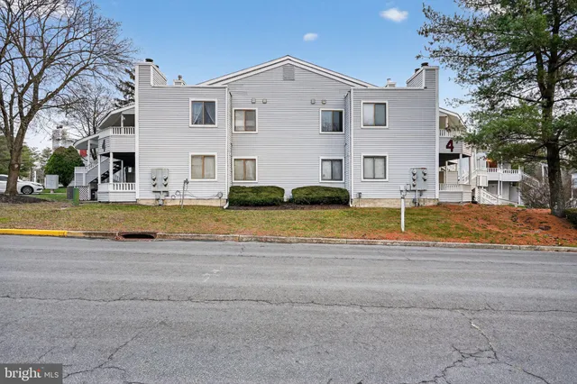 a view of a house with a swimming pool and a yard