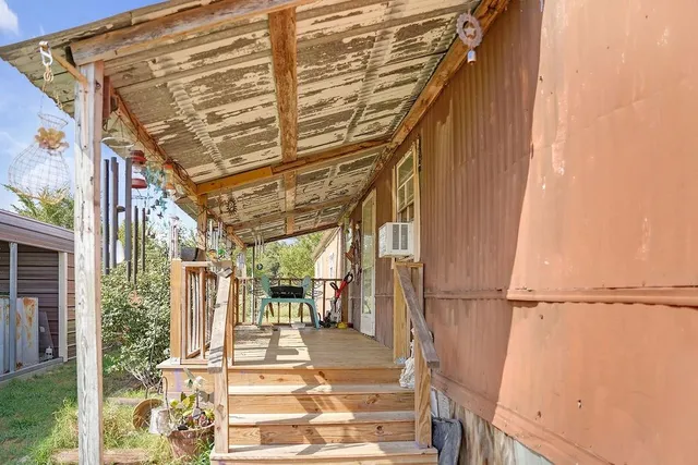 a view of a house with backyard porch and sitting area
