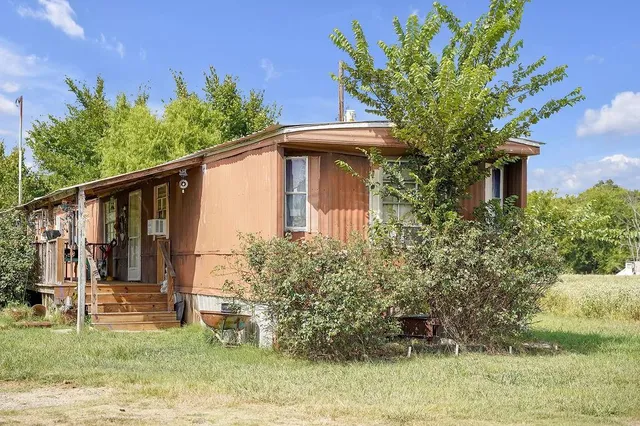 a backyard of a house with wooden fence