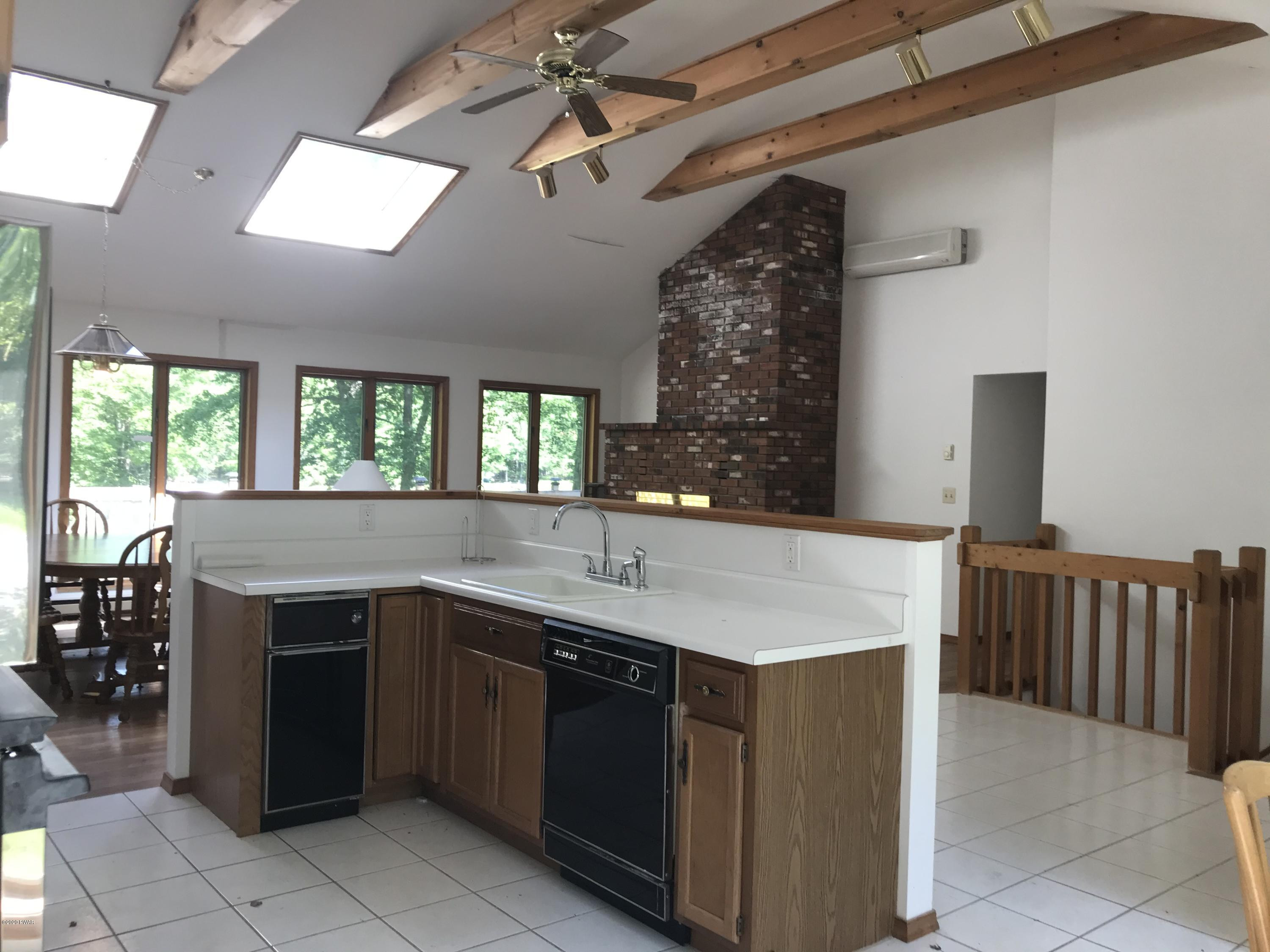 183 Yale Road Milford, PA 18337 - Photo 9 of 26 a kitchen with a sink and chairs