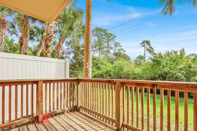 a view of a balcony with wooden floor