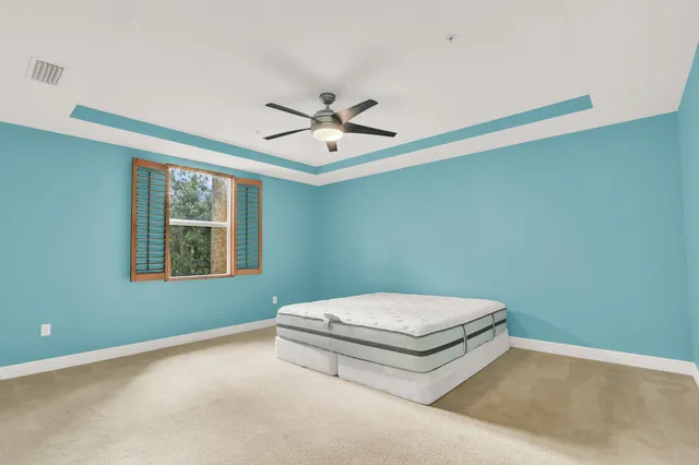 a living room with a bed and a chandelier