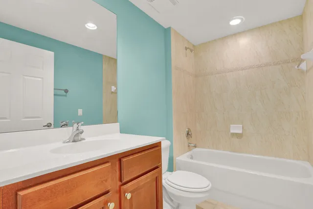 a bathroom with a sink a toilet and bathtub