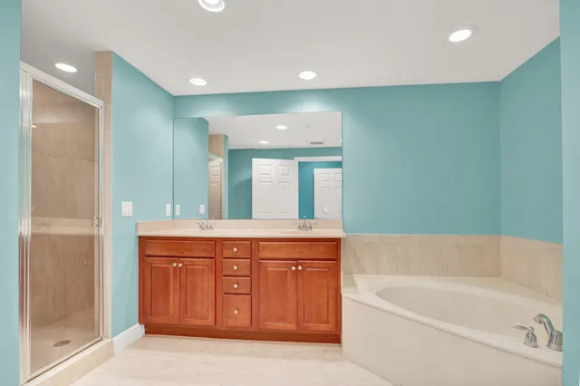 a bathroom with a bathtub sink and mirror