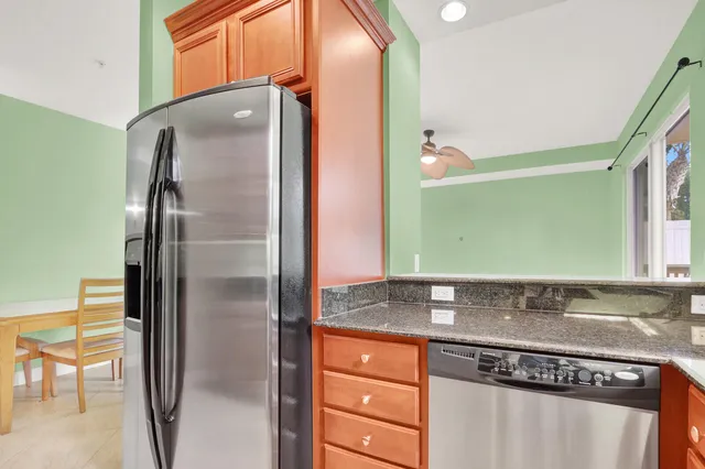 a kitchen with stainless steel appliances granite countertop a refrigerator and a sink