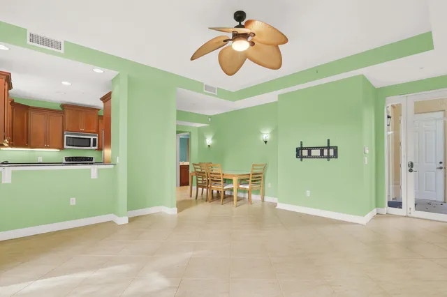a view of a room with a table and chairs