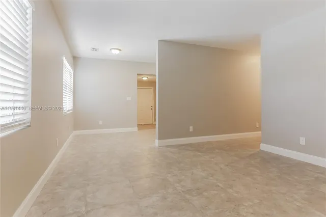 an empty room with windows and entrance