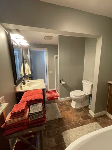 a living room with a sink and a mirror