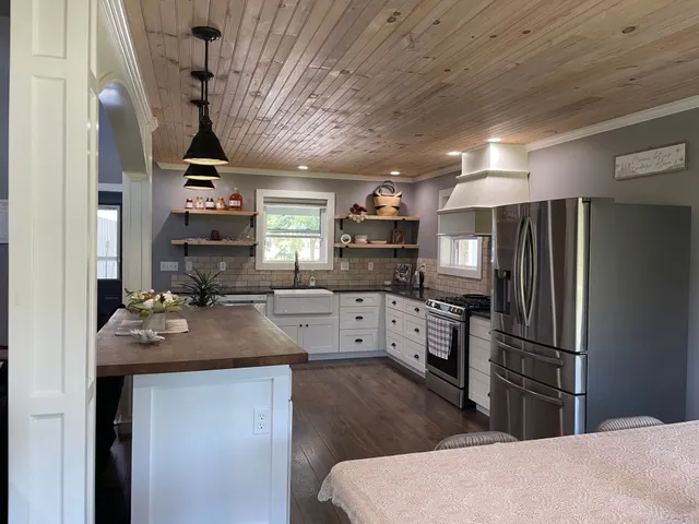 a kitchen with refrigerator a stove and cabinets