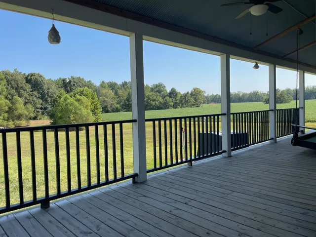 a view of a balcony with wooden floor