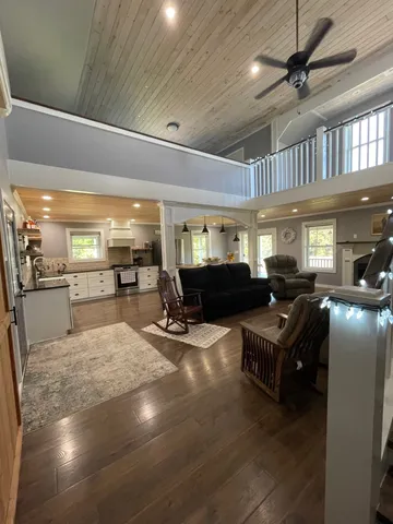 a living room with lots of furniture and a chandelier