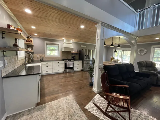a living room with furniture and a kitchen view