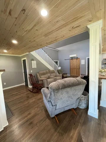 a spacious bedroom with a bed a couch and a table in it