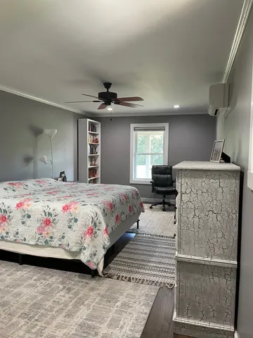 a bedroom with a large bed and a window