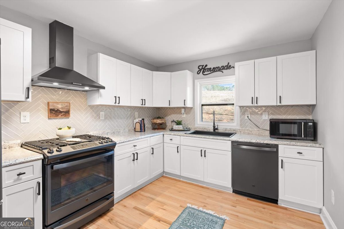 80 Hand Road Bowdon, GA 30108 - Photo 12 of 82 a kitchen with stainless steel appliances granite countertop a stove and a sink