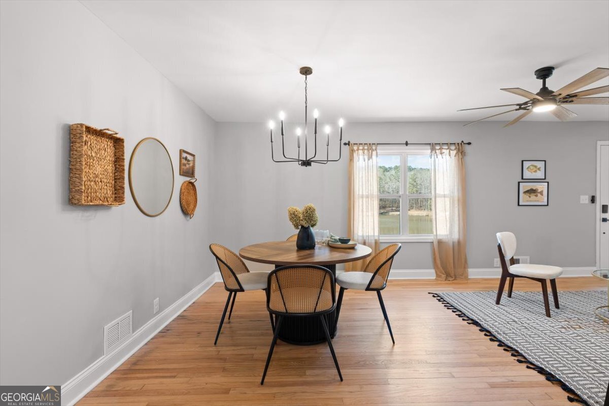 80 Hand Road Bowdon, GA 30108 - Photo 15 of 82 a view of a dining room with furniture a chandelier and wooden floor