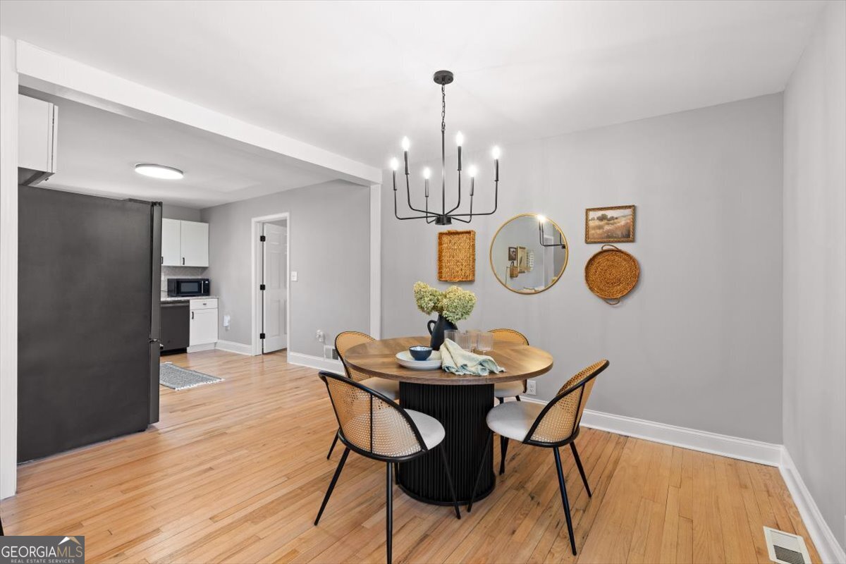 80 Hand Road Bowdon, GA 30108 - Photo 16 of 82 a view of a dining room with furniture and wooden floor