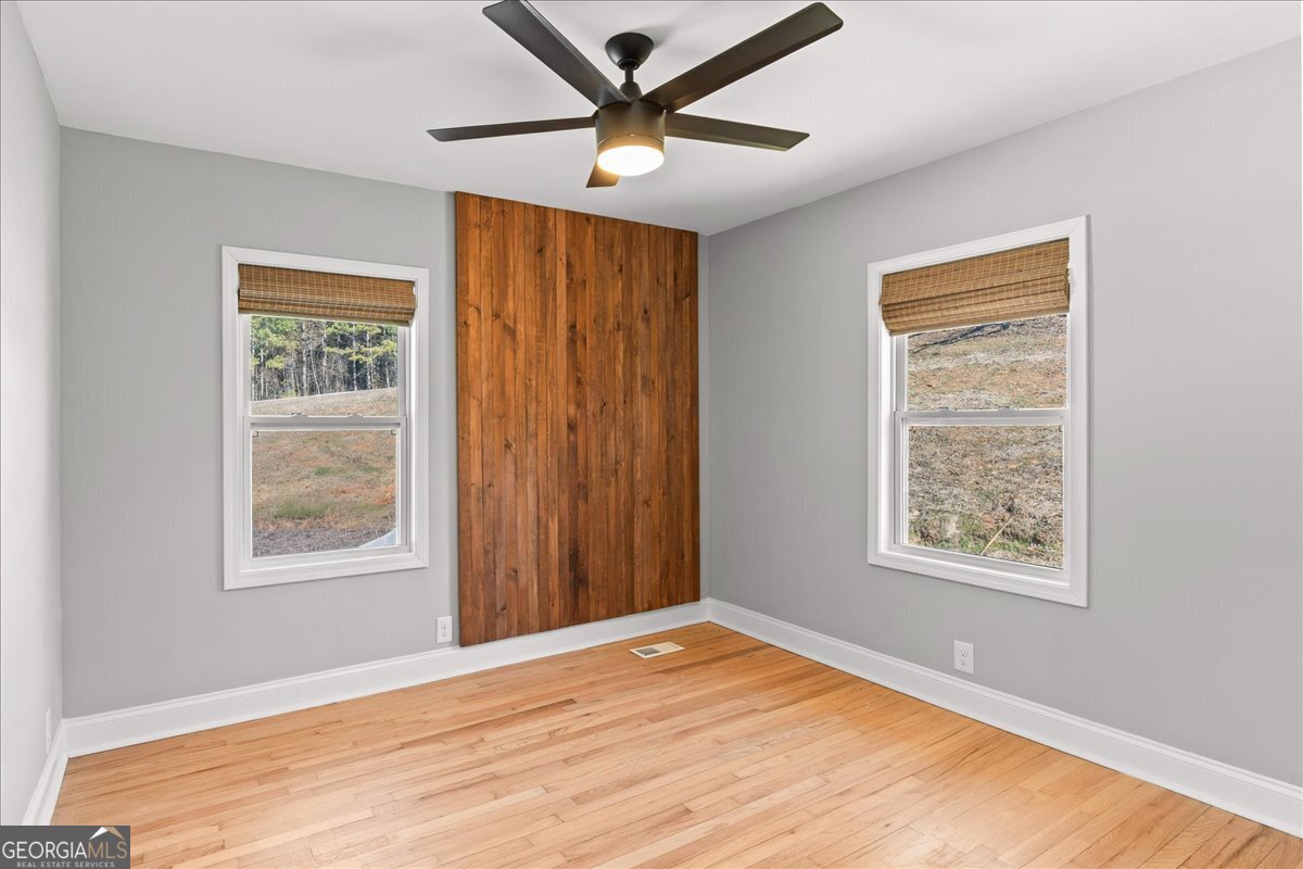 80 Hand Road Bowdon, GA 30108 - Photo 24 of 82 a view of an empty room with window and wooden floor