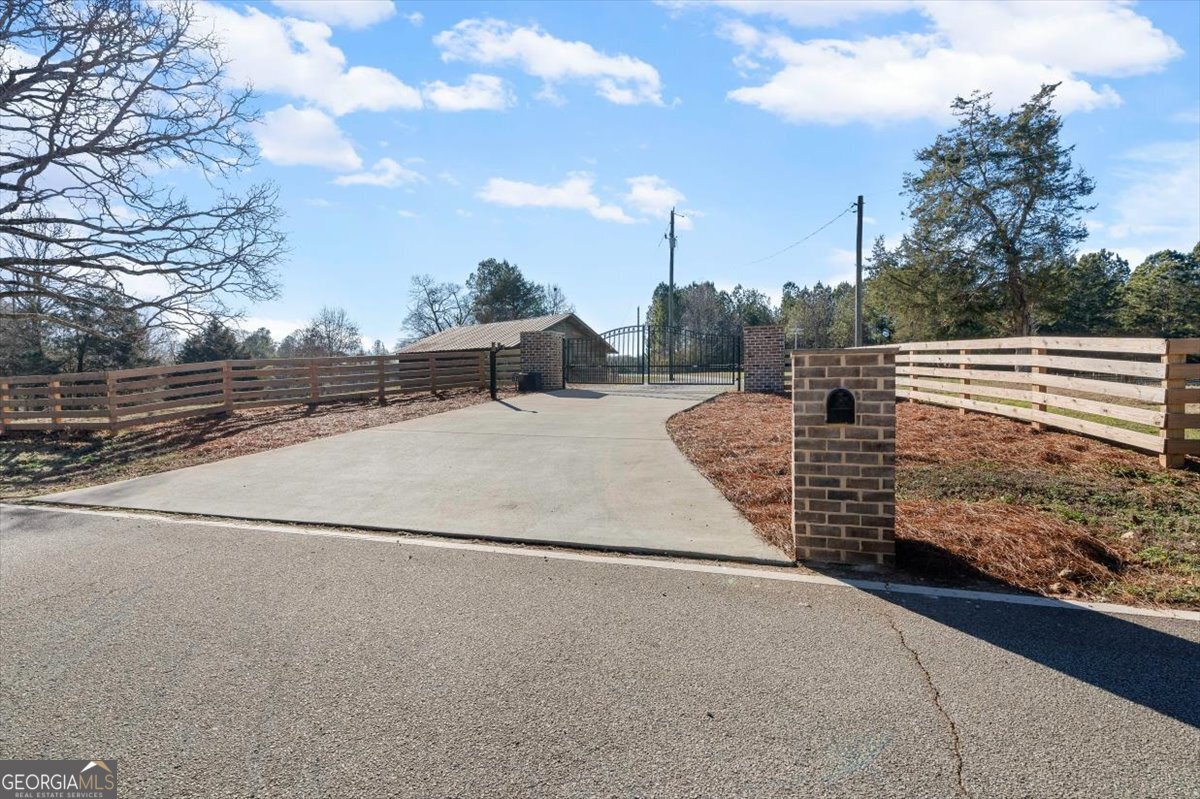 80 Hand Road Bowdon, GA 30108 - Photo 37 of 82 a view of a pathway with a wrought fence