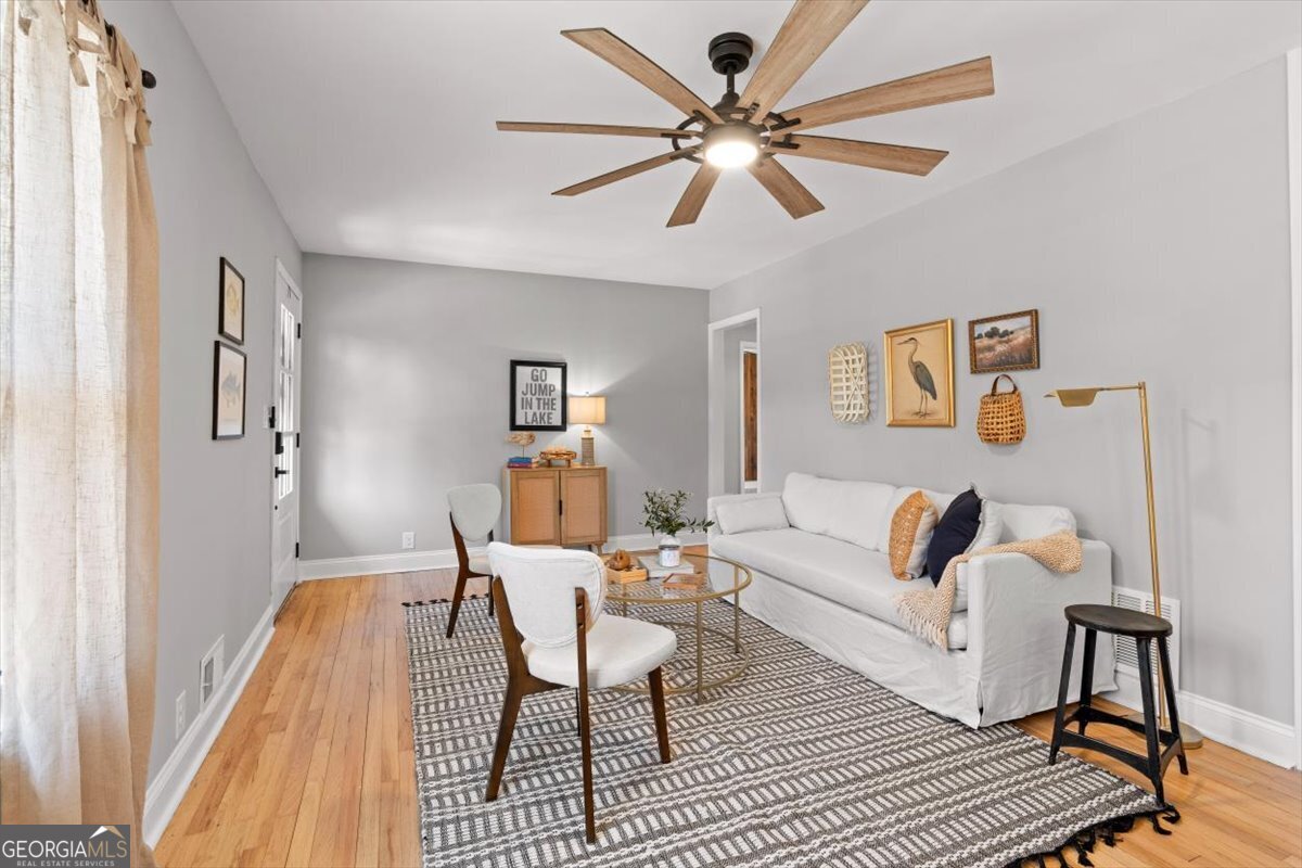 80 Hand Road Bowdon, GA 30108 - Photo 7 of 82 a living room with furniture and a chandelier