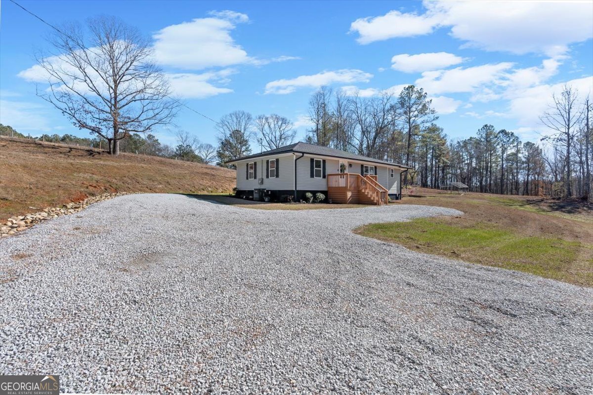 80 Hand Road Bowdon, GA 30108 - Photo 77 of 82 a view of a swimming pool with an outdoor space and seating area