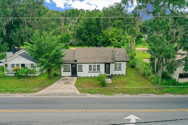 an aerial view of a house with garden space and street view