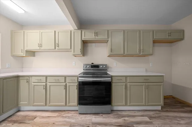 a view of empty room with wooden floor and fireplace