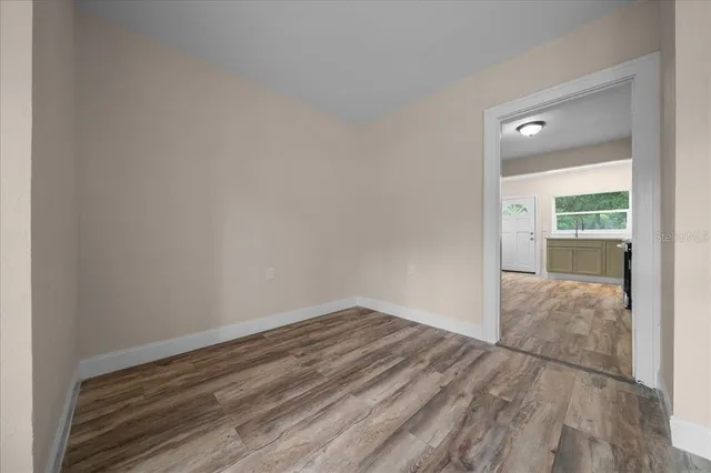 a view of an empty room with a window and closet