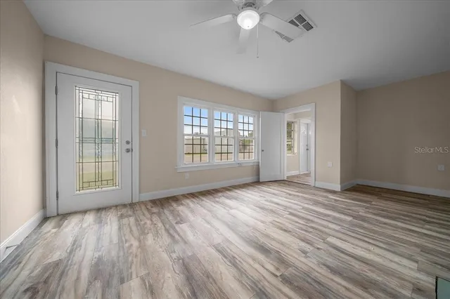 wooden floor in an empty room with a window