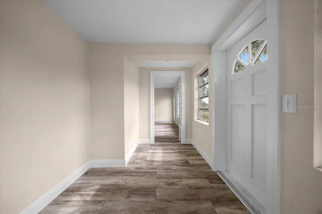 a view of a yard in front of a house with large trees