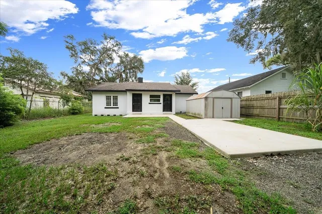 a kitchen with granite countertop a sink stove and refrigerator