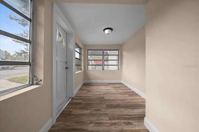 a view of a yard in front of a house with large trees