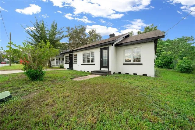 an aerial view of residential houses with outdoor space and street view