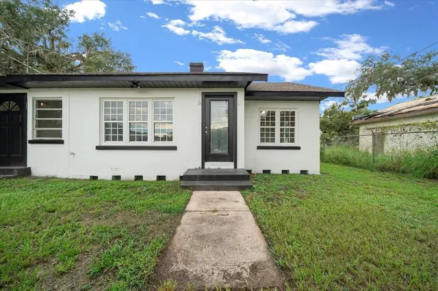 a kitchen with a wooden floor and stainless steel appliances