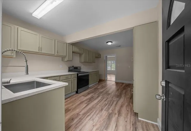 a kitchen with a stove a sink and a refrigerator