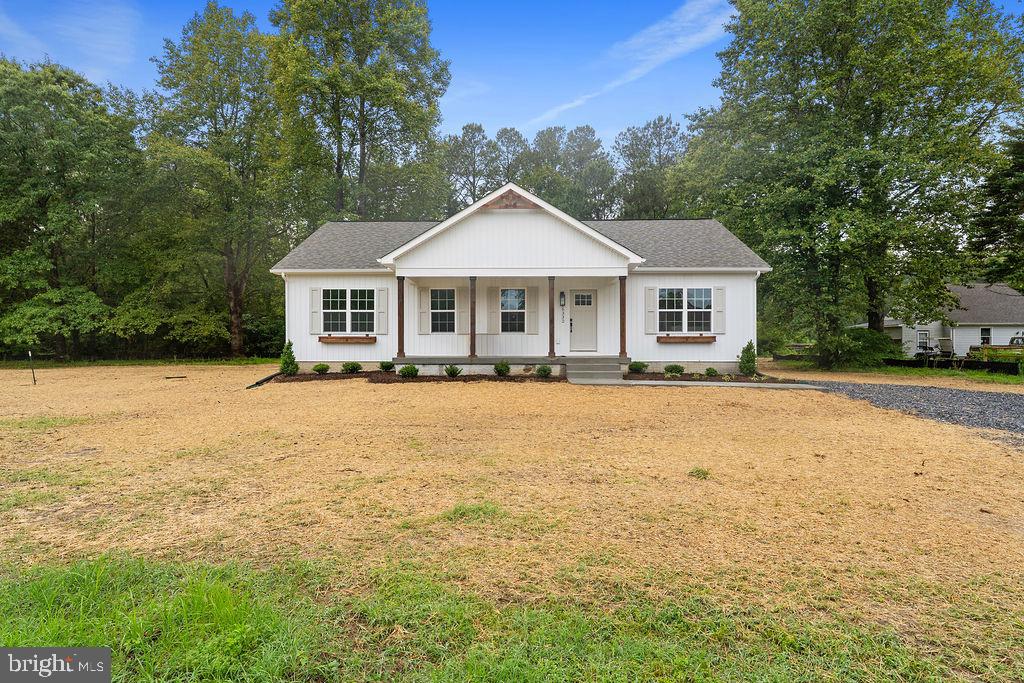 a front view of a house with yard and green space