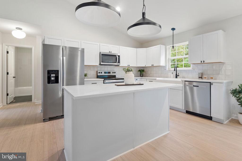 26332 Old Pitts Road Ruther Glen, VA 22546 - Photo 15 of 35 a kitchen with stainless steel appliances a sink a stove a refrigerator cabinets and a window