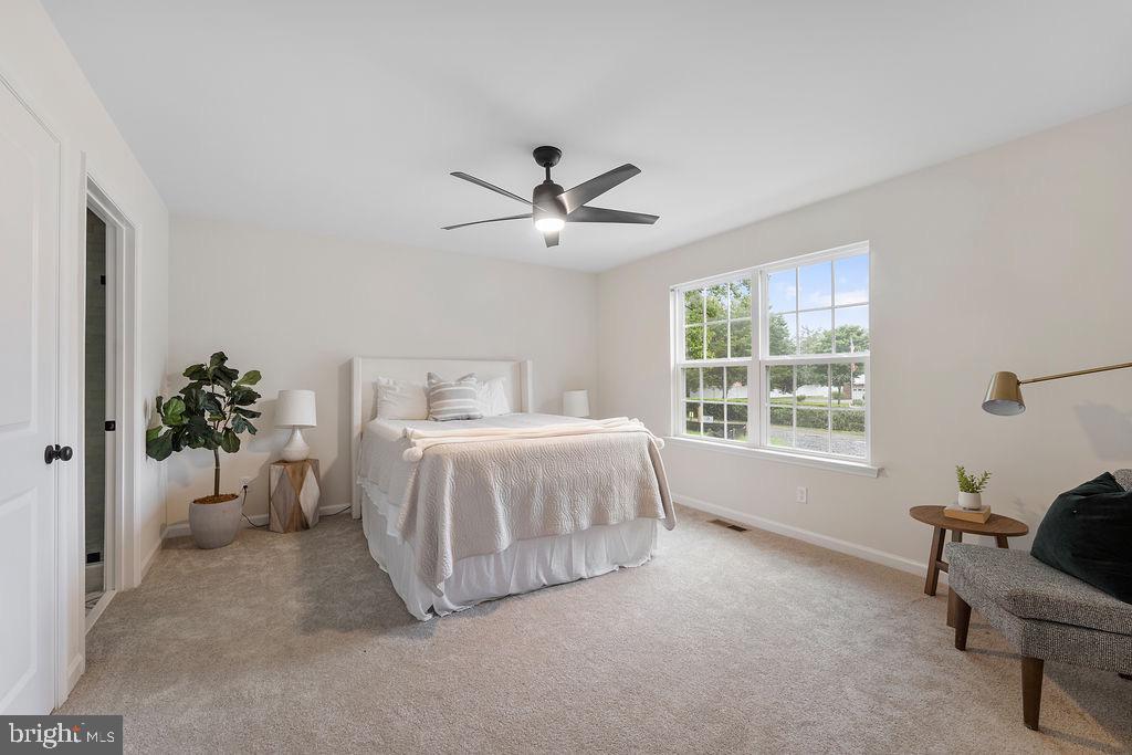 26332 Old Pitts Road Ruther Glen, VA 22546 - Photo 19 of 35 a spacious bedroom with a bed and a couch