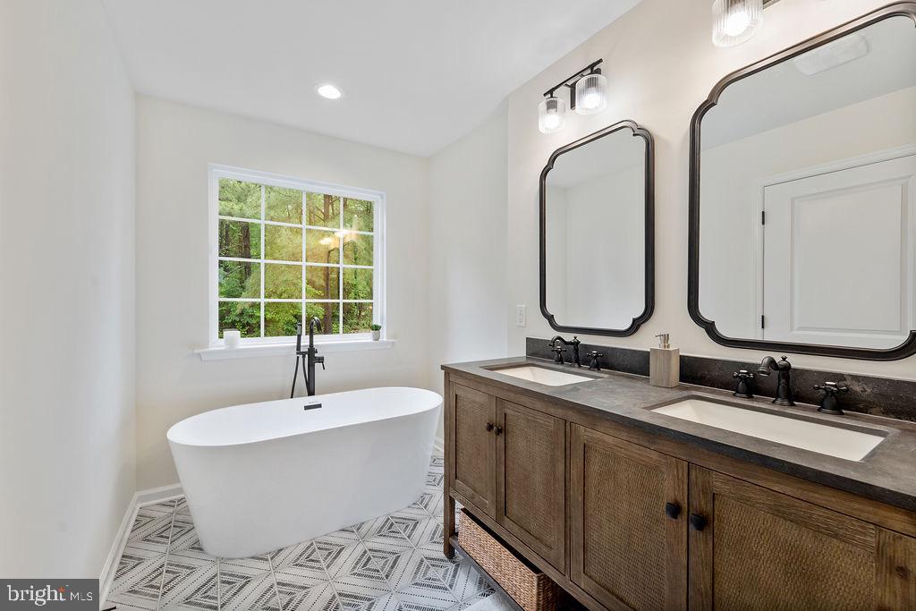 26332 Old Pitts Road Ruther Glen, VA 22546 - Photo 2 of 35 a bathroom with a double vanity sink mirror and bathtub