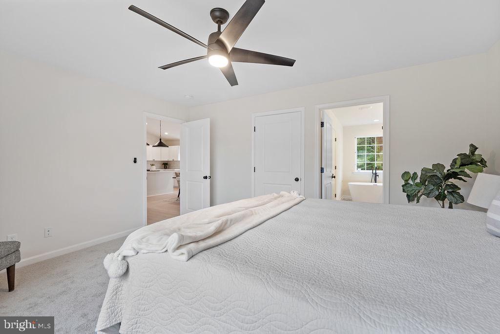 26332 Old Pitts Road Ruther Glen, VA 22546 - Photo 21 of 35 a bedroom with a bed and a ceiling fan