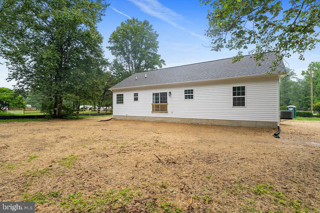 26332 Old Pitts Road Ruther Glen, VA 22546 - Photo 34 of 35 a view of a house with a backyard