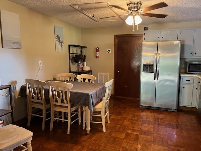 178 Portersville Road Brighton, TN 38011 - Photo 5 of 14 Dining space featuring ceiling fan, dark parquet flooring, and a textured ceiling